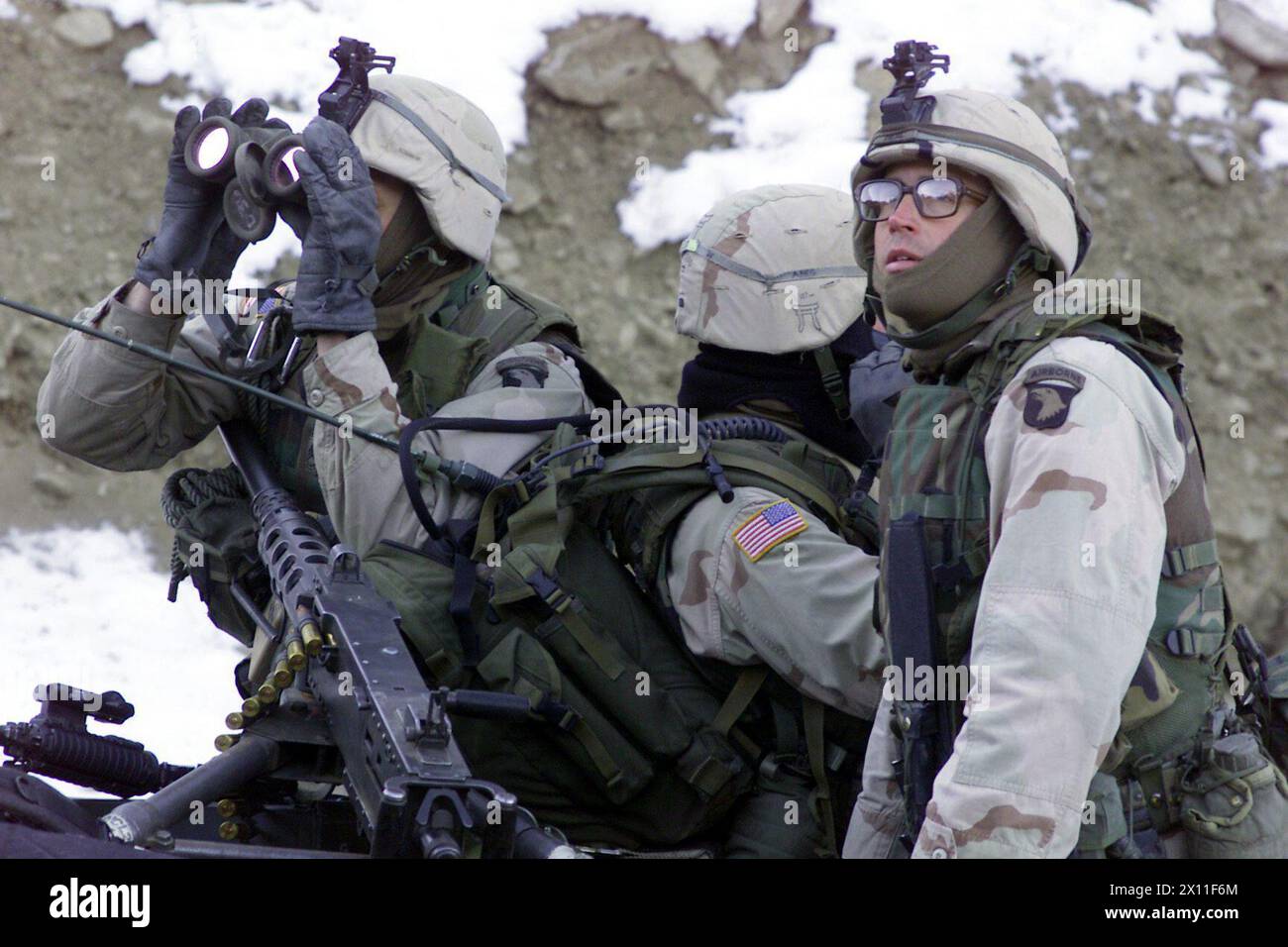 Original Caption: Soldiers from the 1st Battalion, 187th Infantry Regiment, 101st Airborne Division (Air Assault), scan the ridgeline for enemy forces during Operation Anaconda (Afghanistan) March 4 2002. Stock Photo