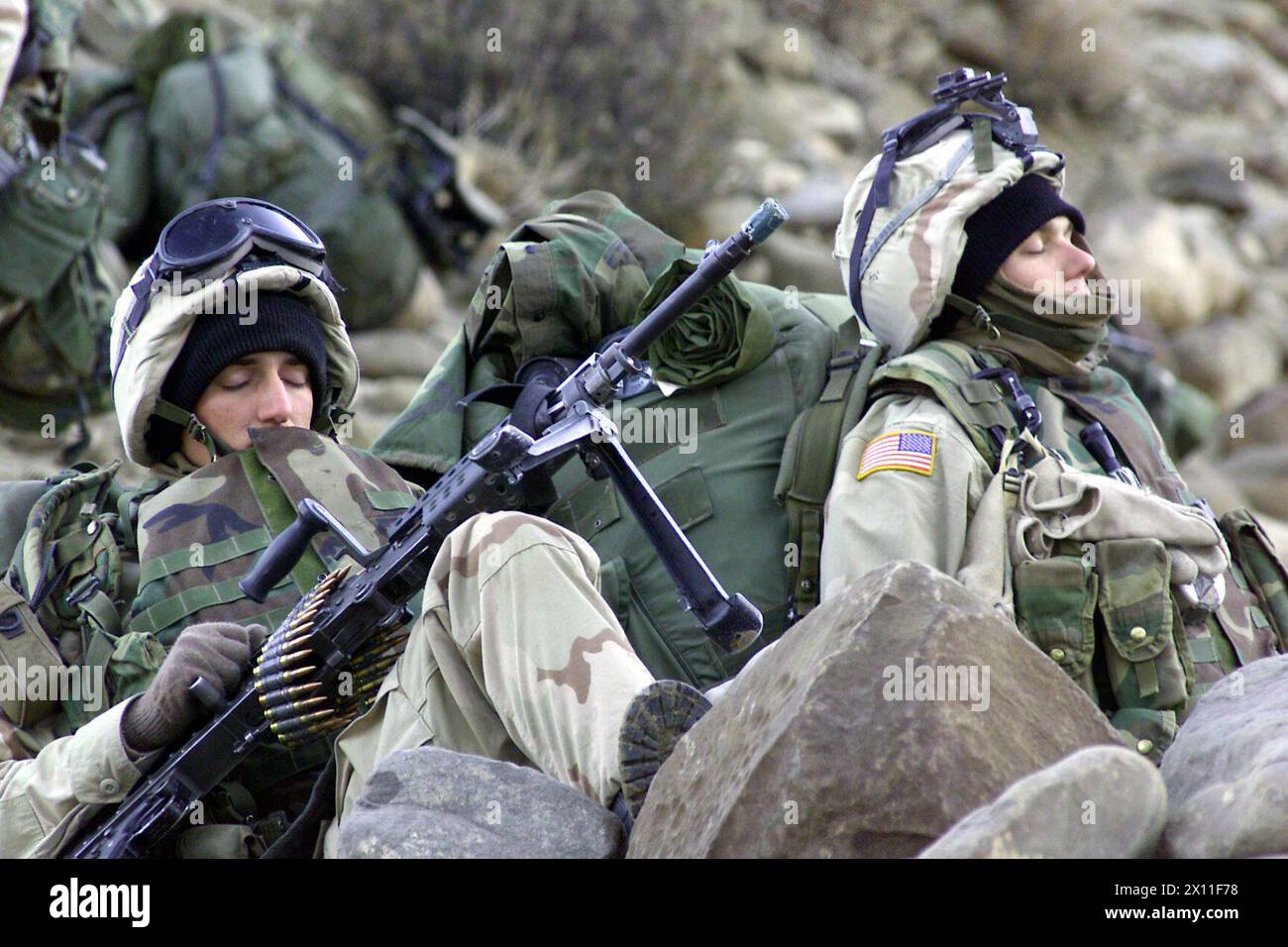 Original Caption: Soldiers from the 1st Battalion, 187th Infantry Regiment, 101st Airborne Division (Air Assault), rest during a break from a march toward an objective, March 4, 2002. The Soldiers are participating in Operation Anaconda, which is part of Operation Enduring Freedom (Afghanistan) Stock Photo
