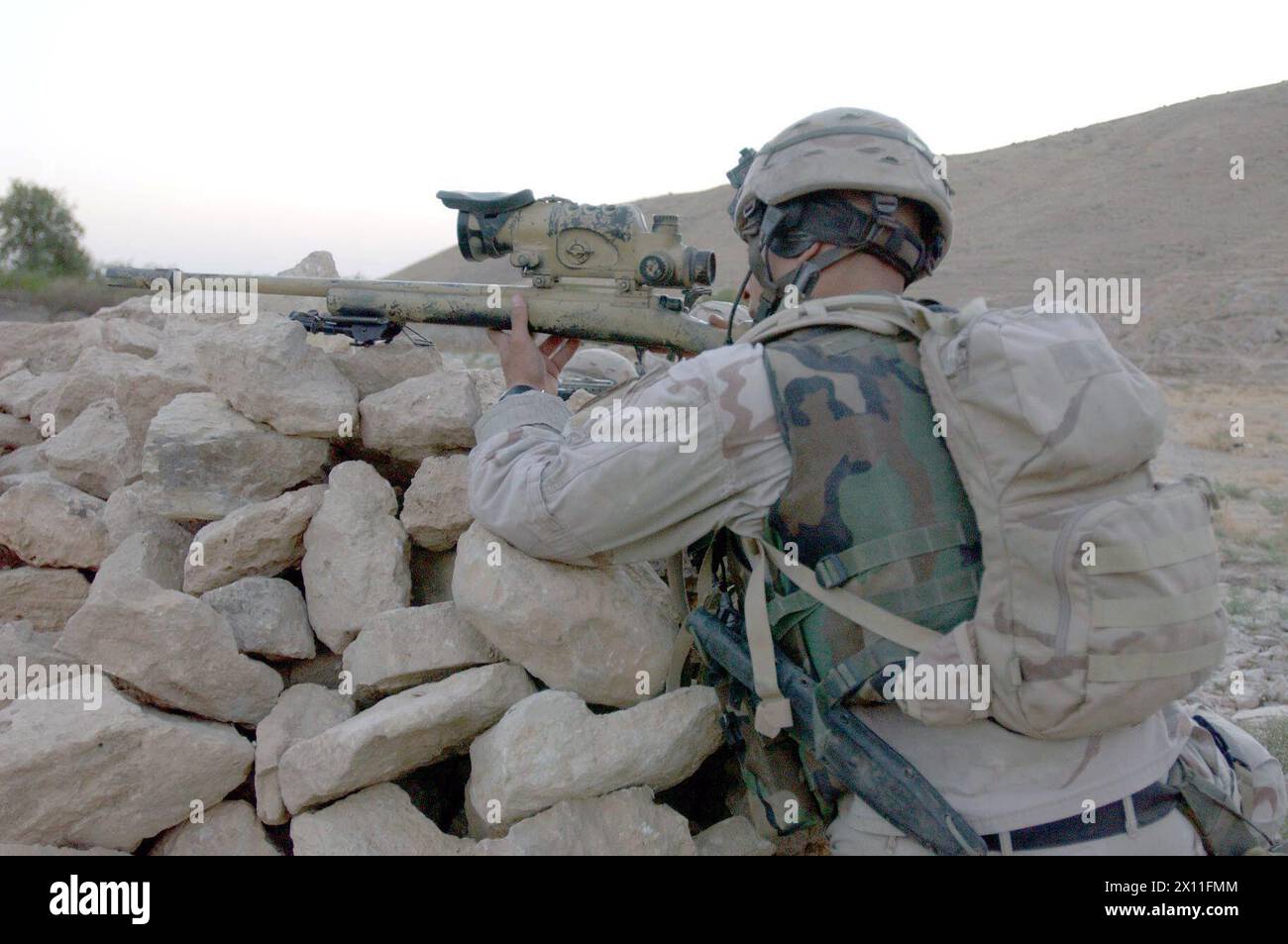 Spc. John Shore prepares to engage the enemy in Avgani, Iraq, Aug. 2, 2004. Shore is a sniper with Company B, 5th Battalion, 20th Infantry Regiment, 3rd Brigade, 2nd Infantry Division (Stryker Brigade Combat Team). Stock Photo