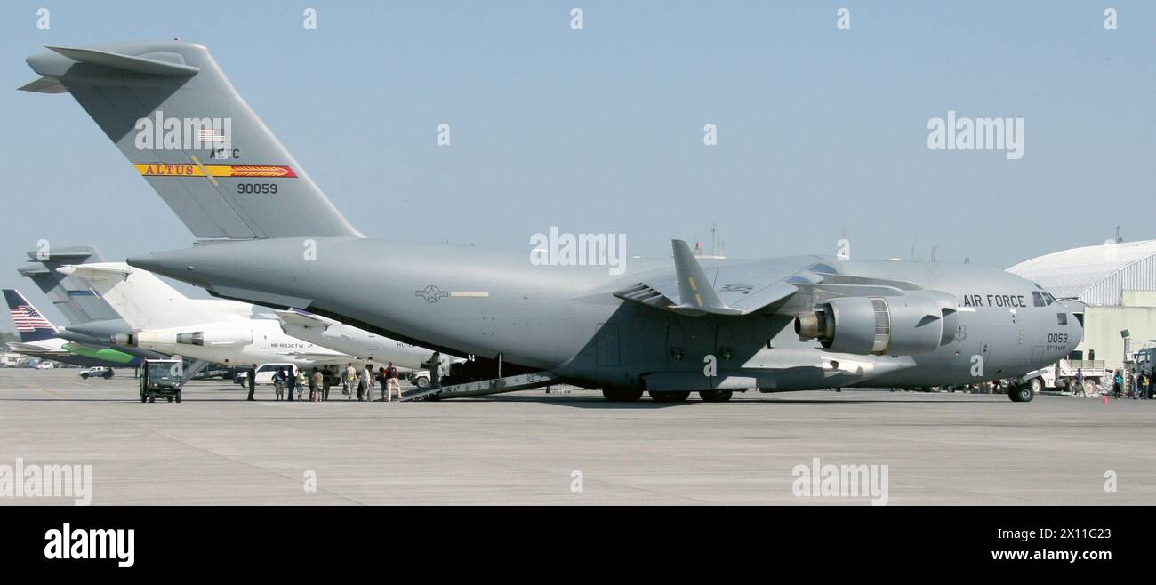 A U.S. Air Force C-17 Globemaster III is loaded with Haitian-American citizens Jan. 22, 2010 to fly them back to the United States at the Toussaint Louverture International Airport in Port-au-Prince, Haiti. Stock Photo