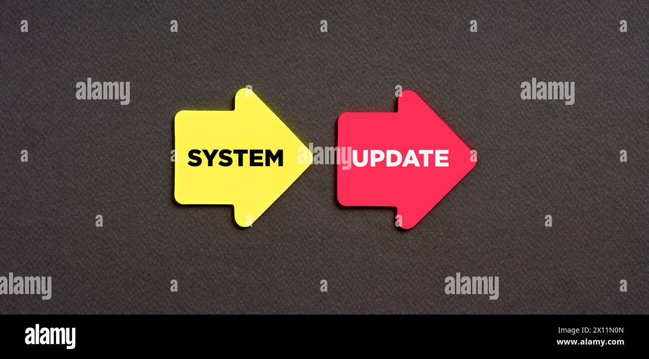 The word system update on arrow shaped stickers on blue background. Software update or operating system upgrade to keep the device up to date with add Stock Photo