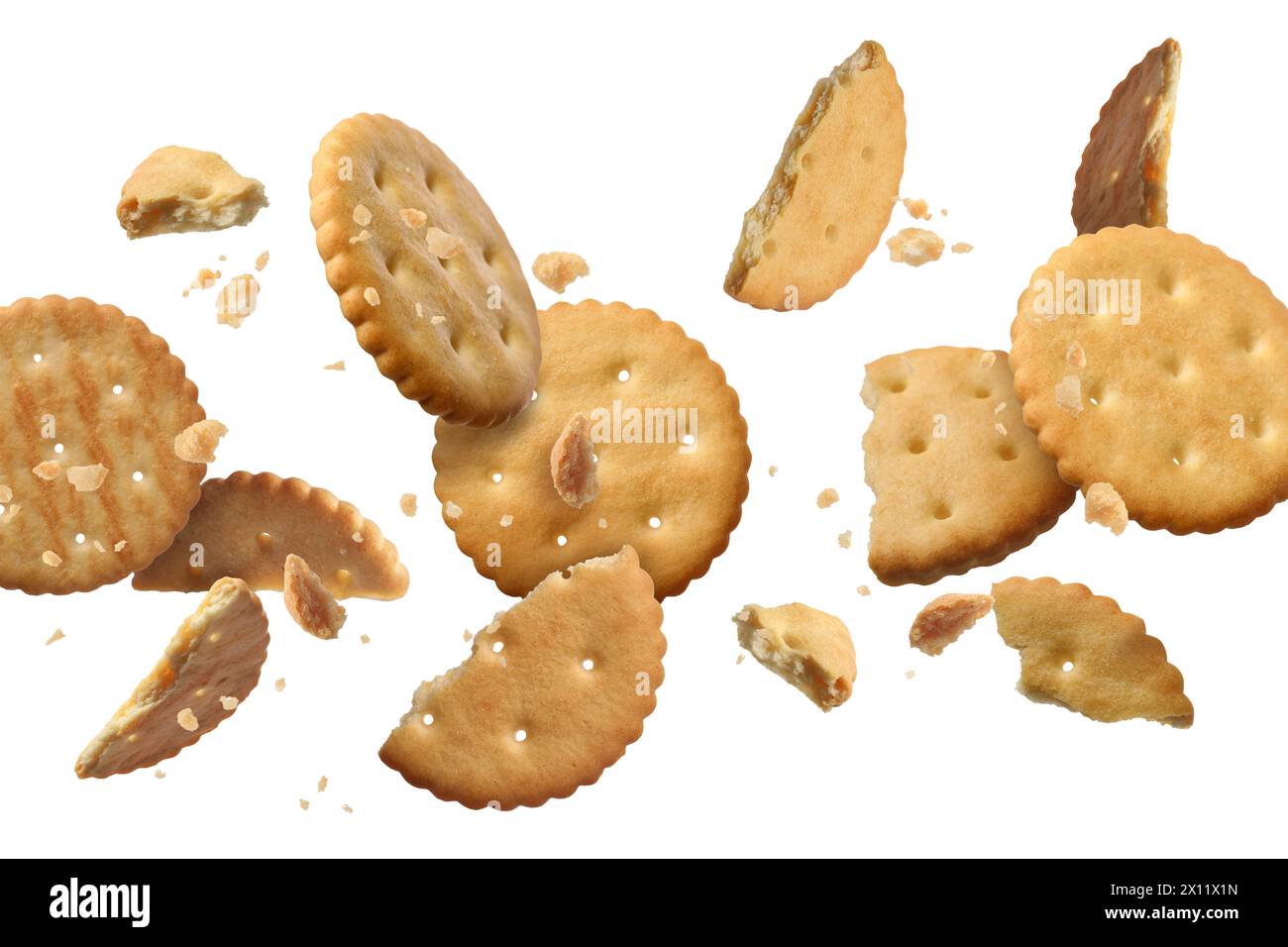 Tasty dry crackers falling on white background Stock Photo