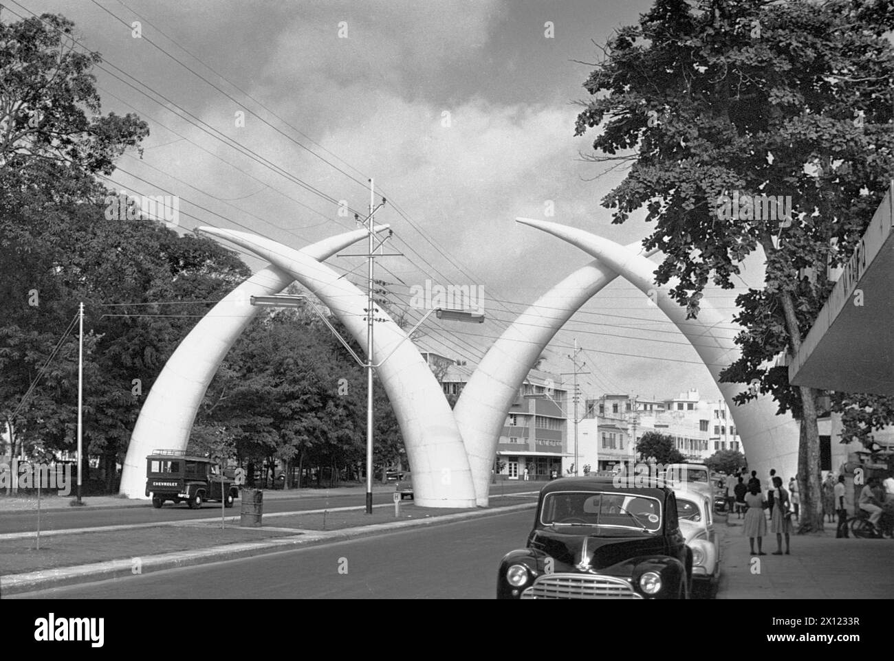 The Mombasa Tusks, Mapemba ya Ndovu or Pembe za Ndovu, a Giant Elephant Tusks Archway or Monument, originally built in 1952, on Moi Avenue Mombasa Kenya. Vintage or Historic Monochrome or Black and White Image c1960. Stock Photo