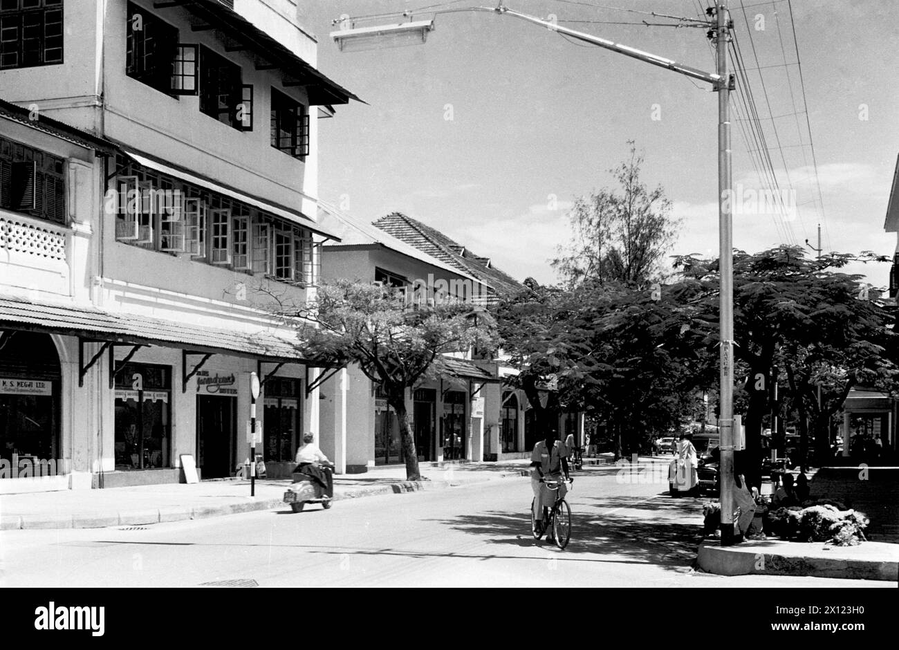 Historic Street Scene on Makunganya Street in the Old Town or Historic District of Dar es Salaam Tanzania, formerly Tanganyika. Vintage or Historic Monochrome or Black and White Image c1960 Stock Photo
