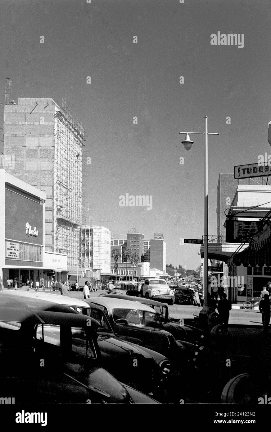 Main Street or High Street in City Centre or Town Centre of Salisbury Rhodesia now Harare Zimbabwe. Street Scene includes (to far left) the Rhodes Cinema. Vintage or Historic  Monochrome or Black and White Image c1960 Stock Photo