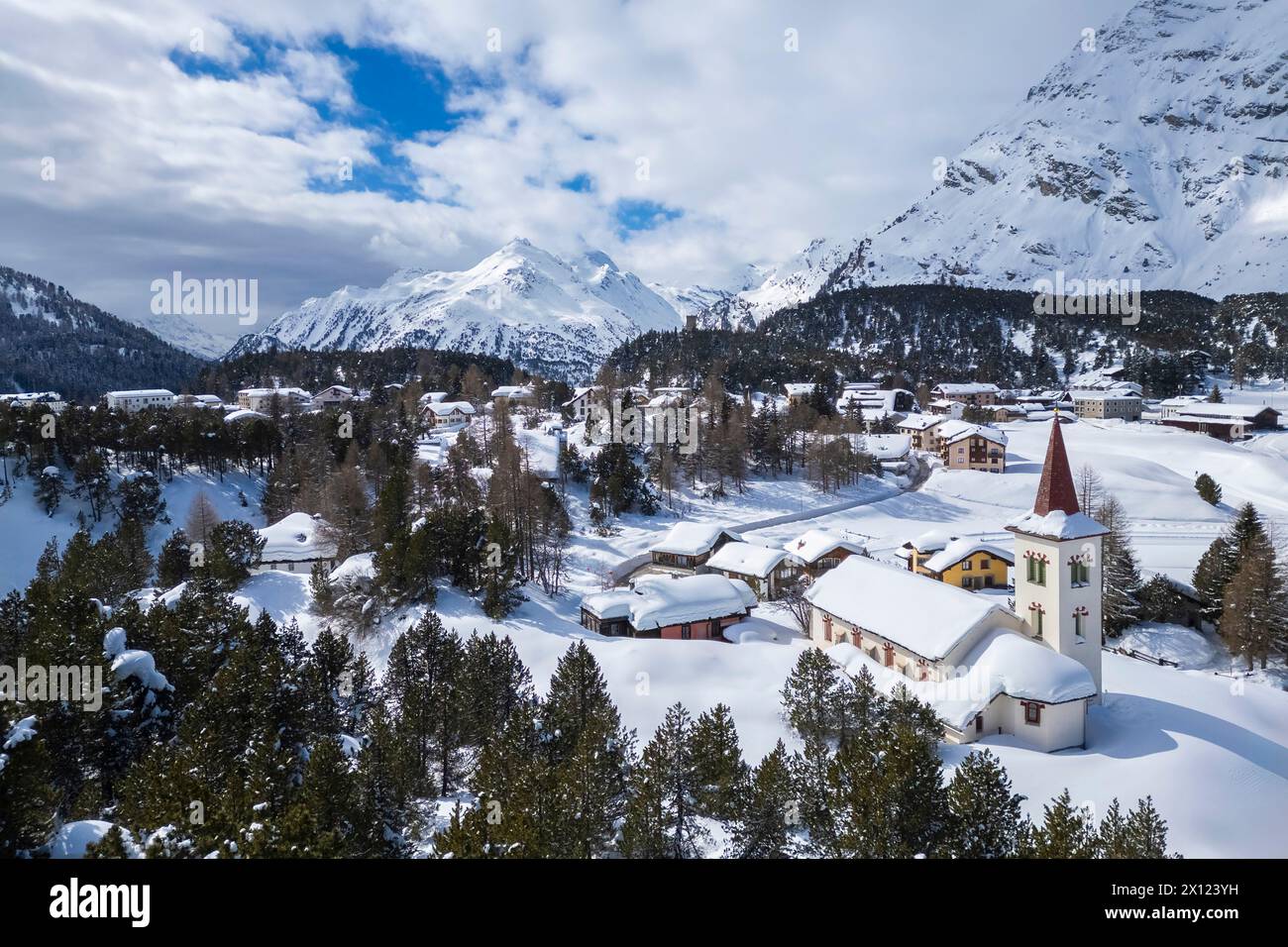 Aerial view of the Chiesa Bianca covered in snow. Maloja, Bregaglia, canton of Graubunden, Engadin, Switzerland. Stock Photo