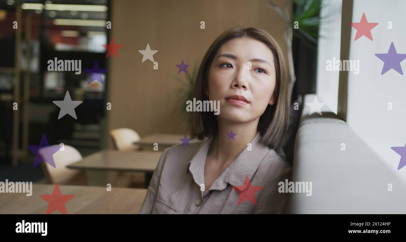 Image of stars of flag of usa over asian businesswoman in office Stock Photo