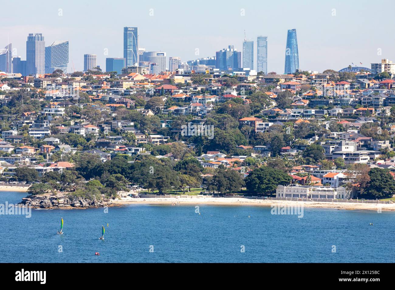 Sydney Australia, Balmoral and Edwards Beach harbour beaches in North Sydney and housing with Sydney city centre cityscape behind with skyscrapers Stock Photo