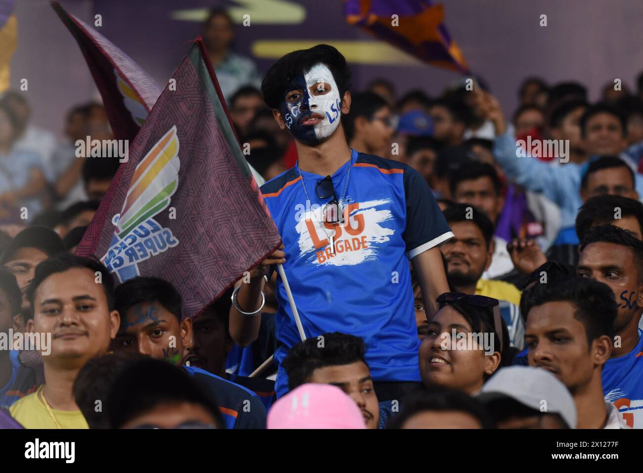 A Lucknow Super Giants fan with their face painted is seen during the Indian Premier League (IPL) Twenty 20 cricket match between Kolkata Knight Riders and Lucknow Super Giants at the Eden GardensKolkata Knight Riders beat Lucknow Super Giants by 8 wickets Stock Photo