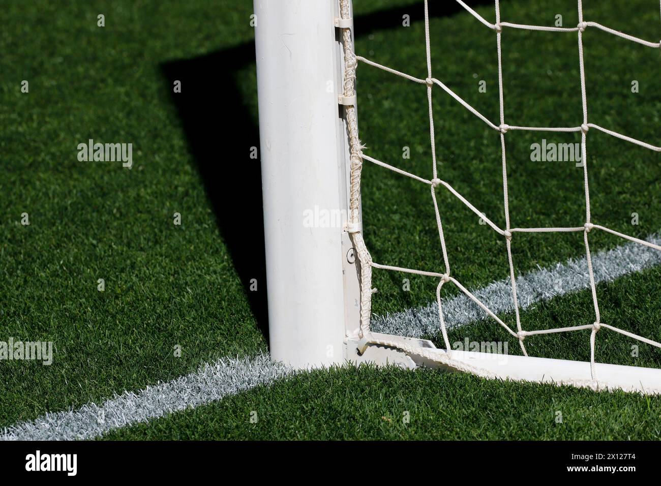 football goalpost standing tall against the backdrop of the pitch. Stock Photo