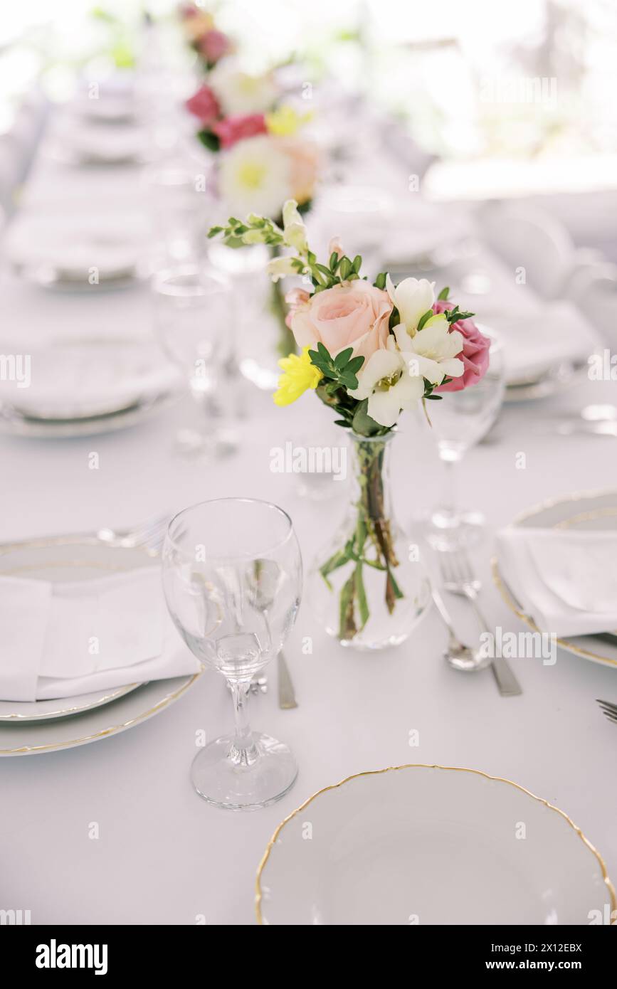 Elegant table setting with fresh flower centerpiece Stock Photo