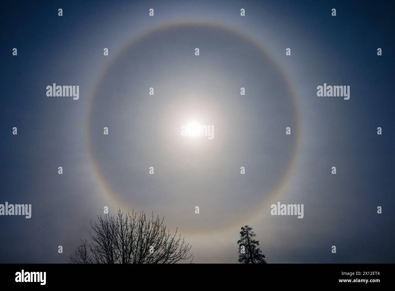 Dramatic sky with full sun halo Stock Photo - Alamy