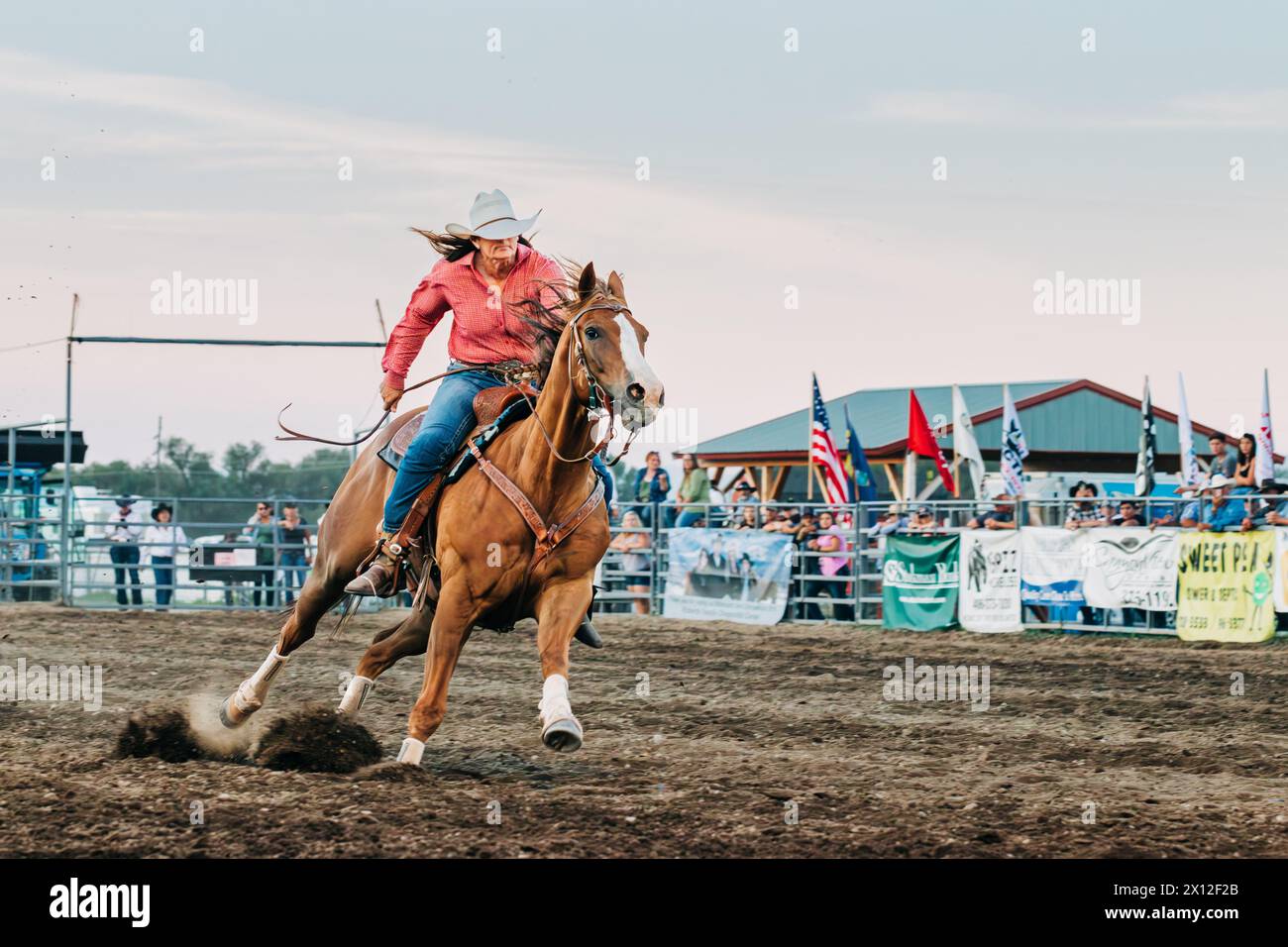 Cowgirl riding on horse at county fair rodeo Stock Photo