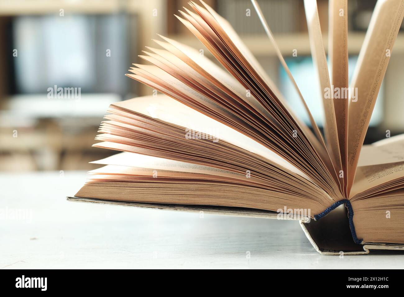open book with blurred office in the background, reading, business,knowledge,learning, education or home office concept Stock Photo