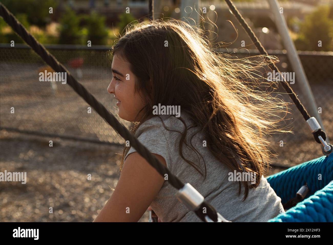 Girl on a swing with long hair hi-res stock photography and images - Alamy