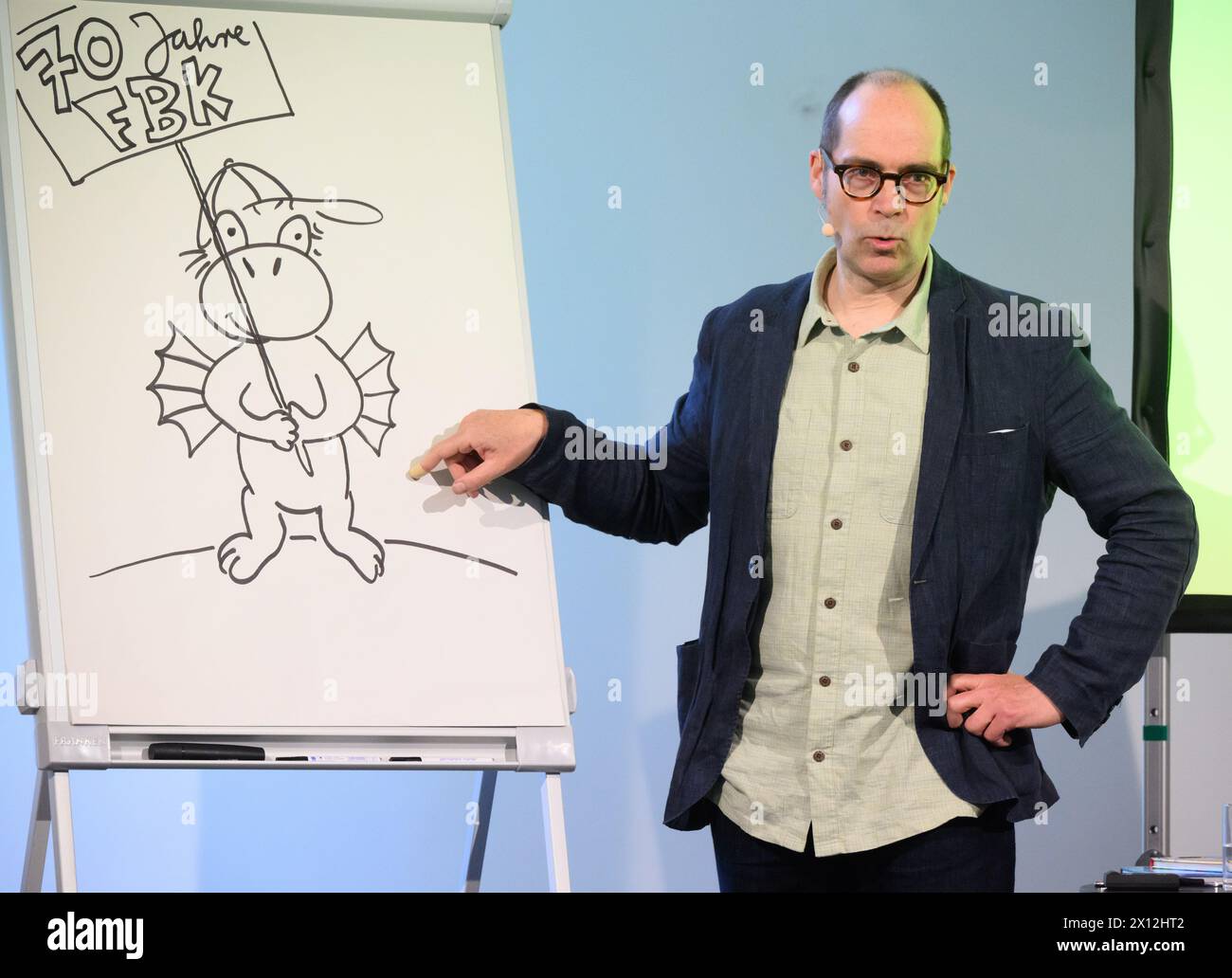 Hanover, Germany. 15th Apr, 2024. Children's book author Ingo Siegner speaks at a reading for primary school children at the Künstlerhaus Hannover. To mark the 70th anniversary of the Friedrich-Bödecker-Kreis Niedersachsen (FBK), 70 readings were held by authors for daycare centers and schools in Lower Saxony. Children's book author Ingo Siegner read from his Drache-Kokosnuss books. Credit: Julian Stratenschulte/dpa/Alamy Live News Stock Photo