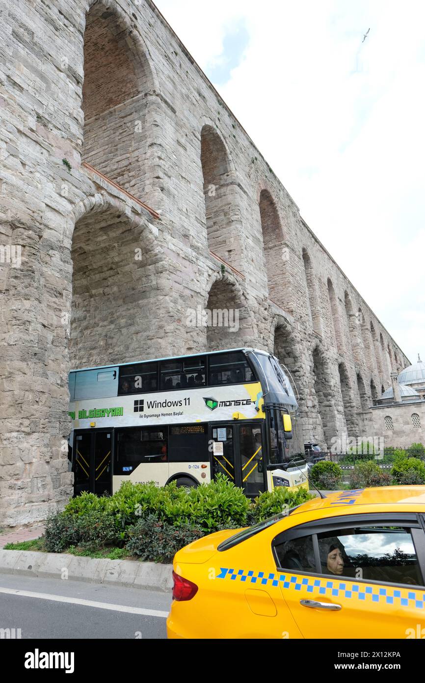 Istanbul Turkey - the ancient Roman Aqueduct of Valens ( 4th Century ) straddles the modern busy Atatürk Boulevard in the Fatih district of Istanbul Stock Photo