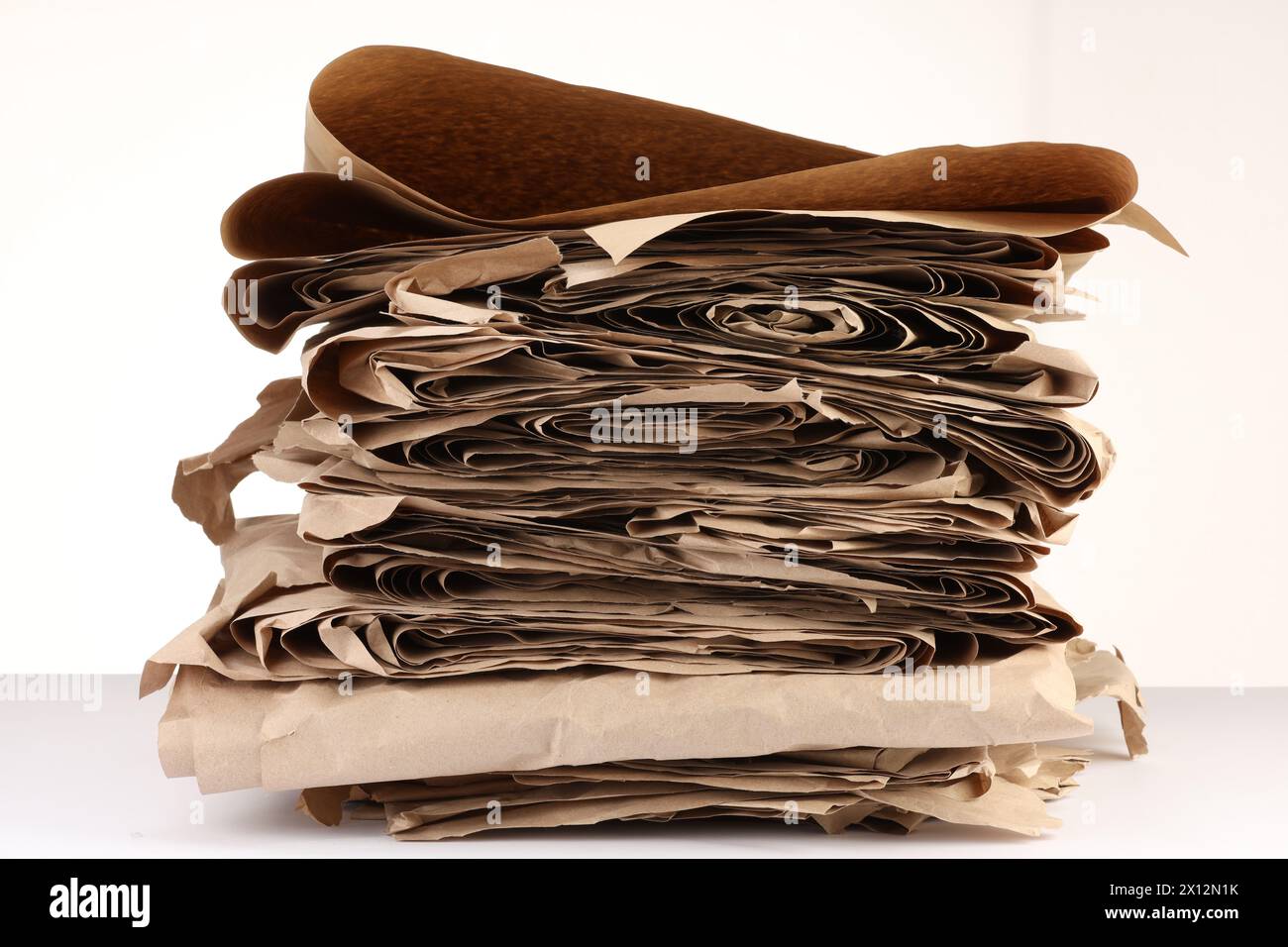 Stack of waste paper isolated on white Stock Photo - Alamy