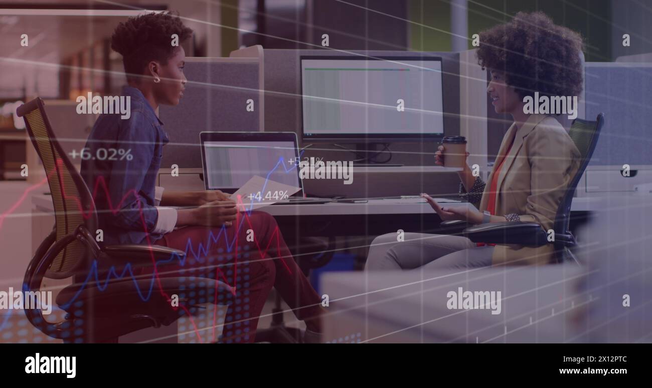 Image of statistical data processing against two diverse women discussing at office Stock Photo
