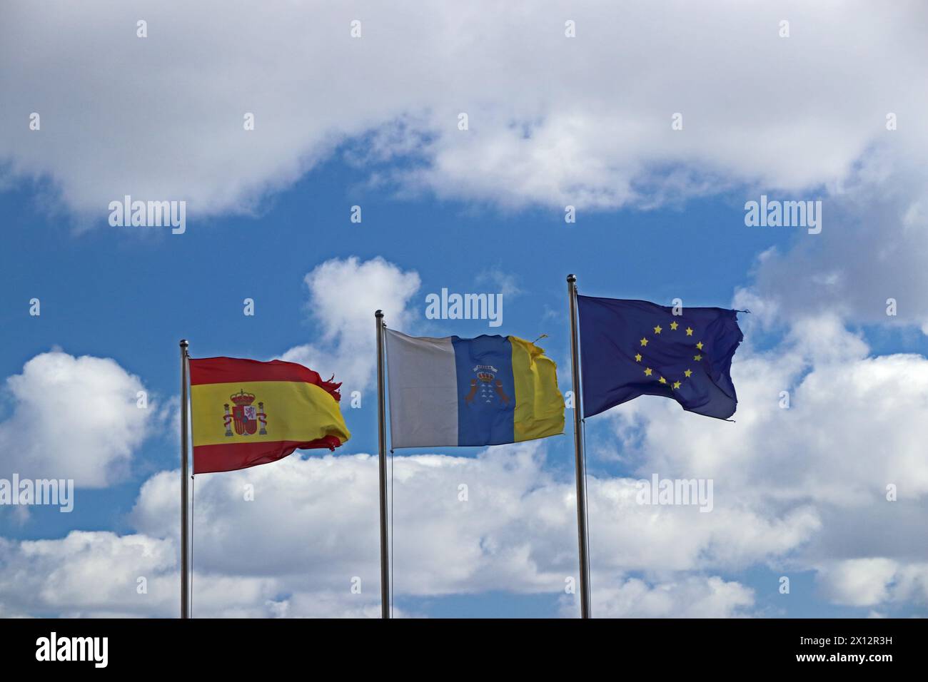 Flags of Spain, Canary Islans and EU flying Stock Photo