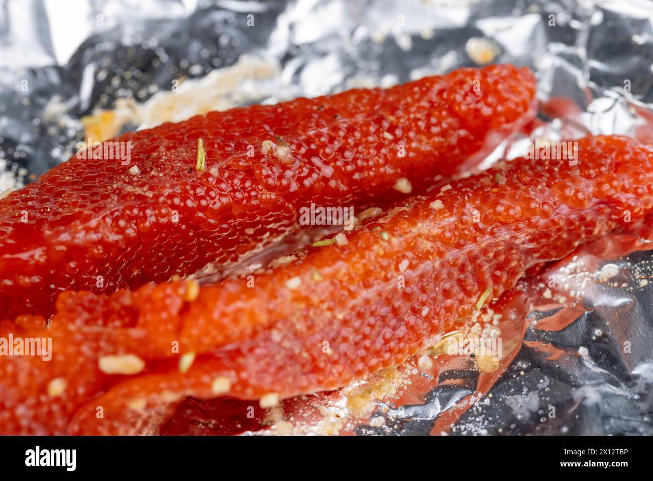 red trout caviar while cooking in foil, cooking a fish dish with ...