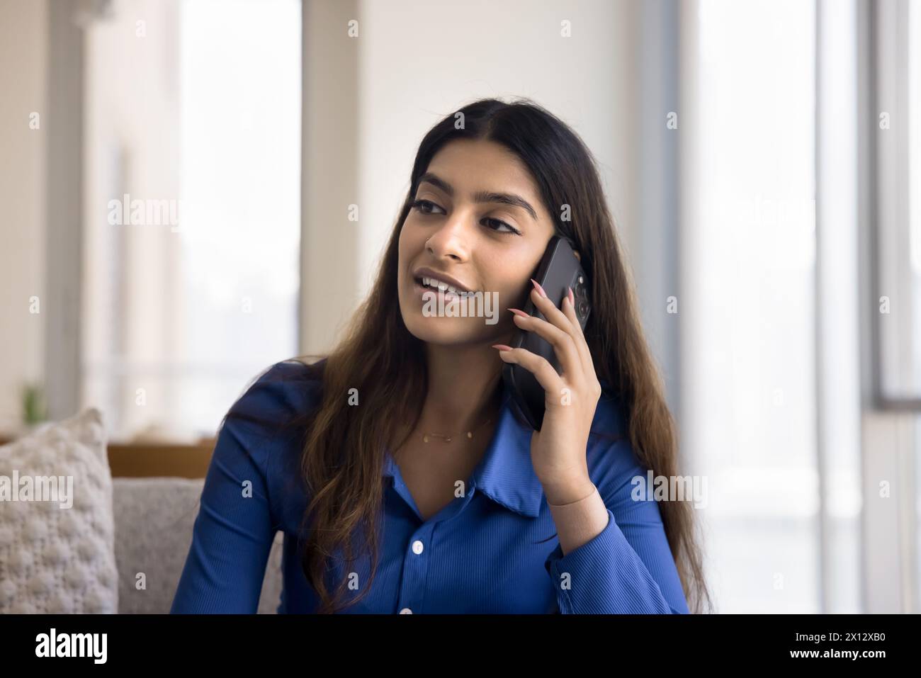 Positive young Indian woman talking on mobile phone Stock Photo - Alamy