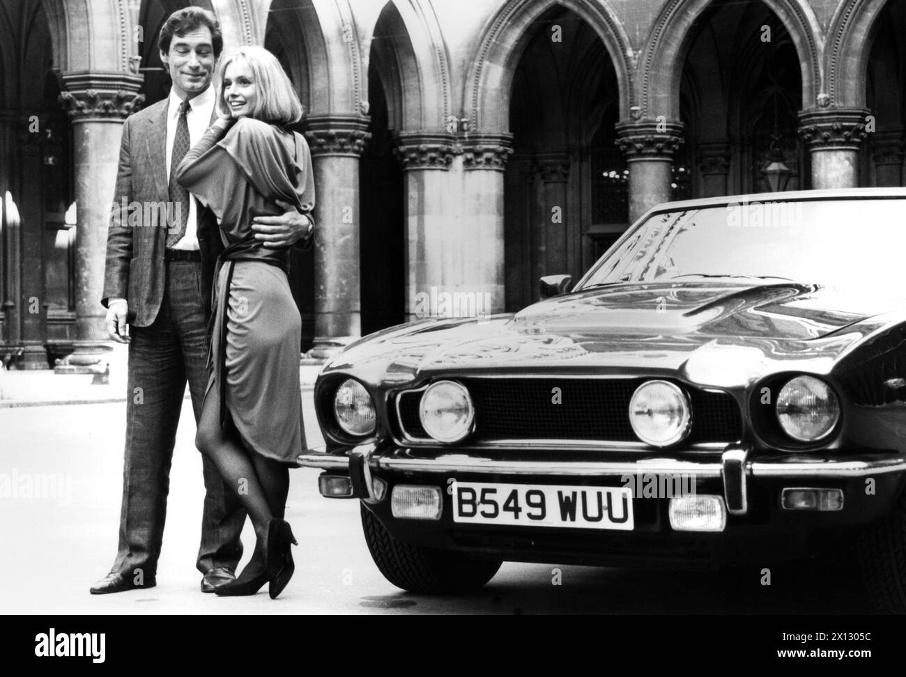 Vienna, on October 5th 1986: A new 'James Bond' naturally needs a new luxurious car. Picture: Timothy Dalton (007) with actress Maryam d'Abo beside this special purpose vehicle, an Aston Martin 'V8' Volante Coupe, in the court of the townhall of Vienna, Austria. - 19861005 PD0005 - Rechteinfo: Rights Managed (RM) Stock Photo