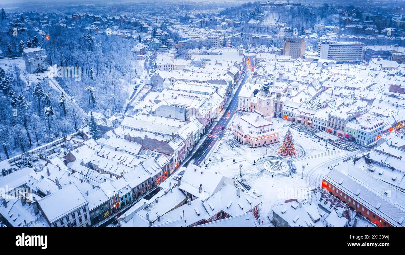 Brasov, Romania, Transylvania - Council Square and Christmas Tree, aerial winter view. Stock Photo