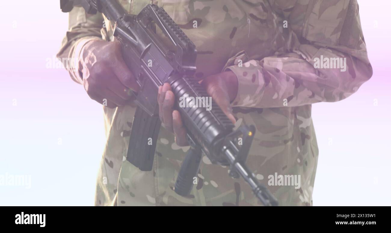 Image of portrait african american army solider holding gun and multicolored moving lens flare Stock Photo