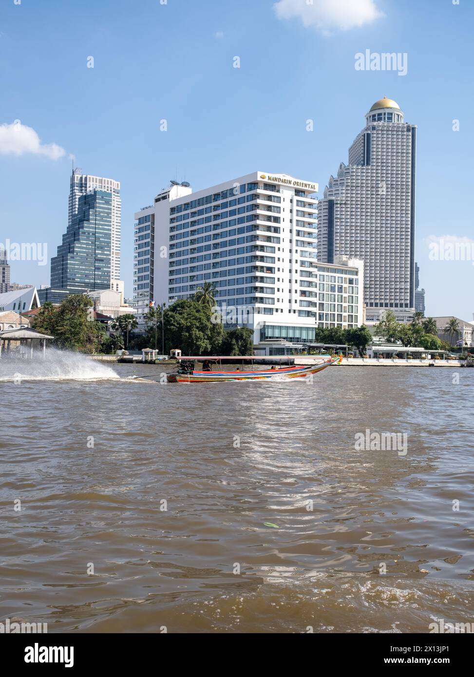 Speeding Long Boat on the Chao Phraya River in fron tof the Mandarin Oriental Hotel in Bangkok Thailand Stock Photo