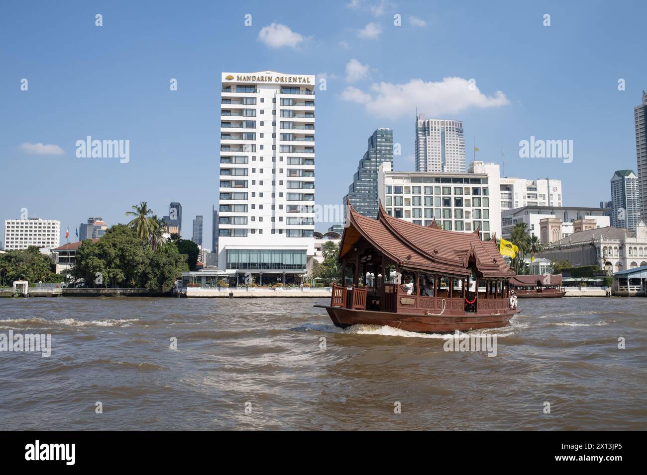 Oriental Hotel Passenger Ferry Boat on the Chao Phraya River in front of the Mandarin Oriental Hotel in Bangkok Thailand Stock Photo