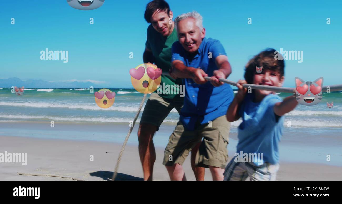 Image of failing emoji over caucasian family on the beach Stock Photo