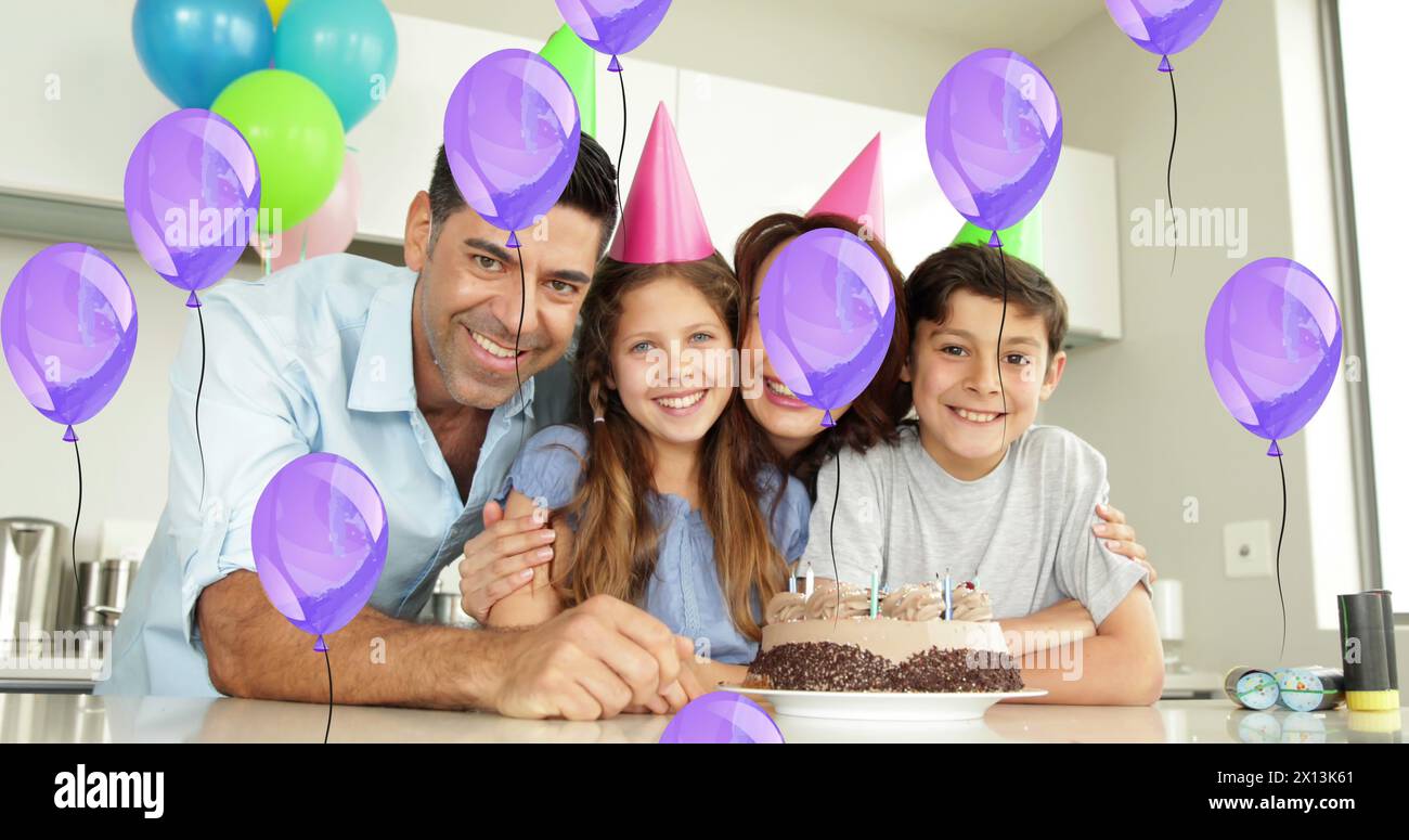 Image of failing balloons over caucasian family celebrating birthday Stock Photo