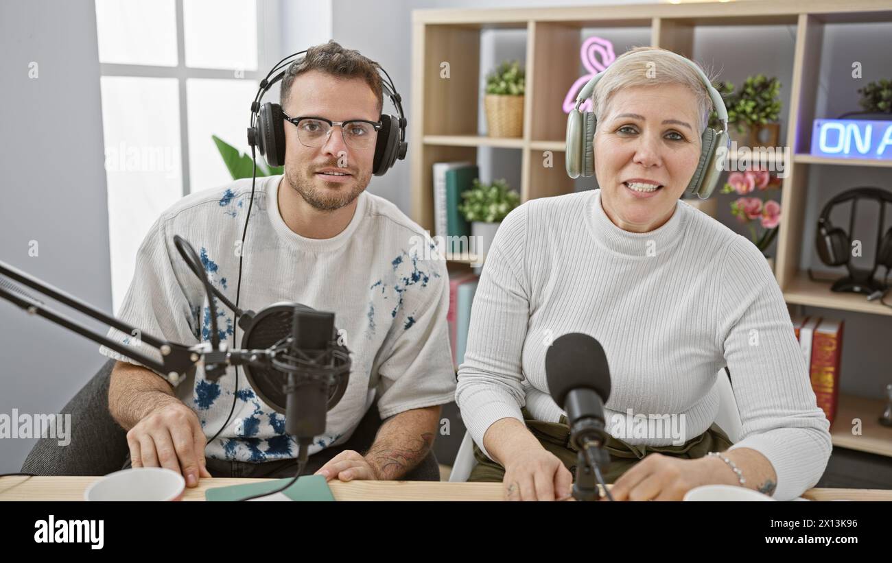 Bright Radio Man and woman wearing headphones speaking into microphones in a bright ...