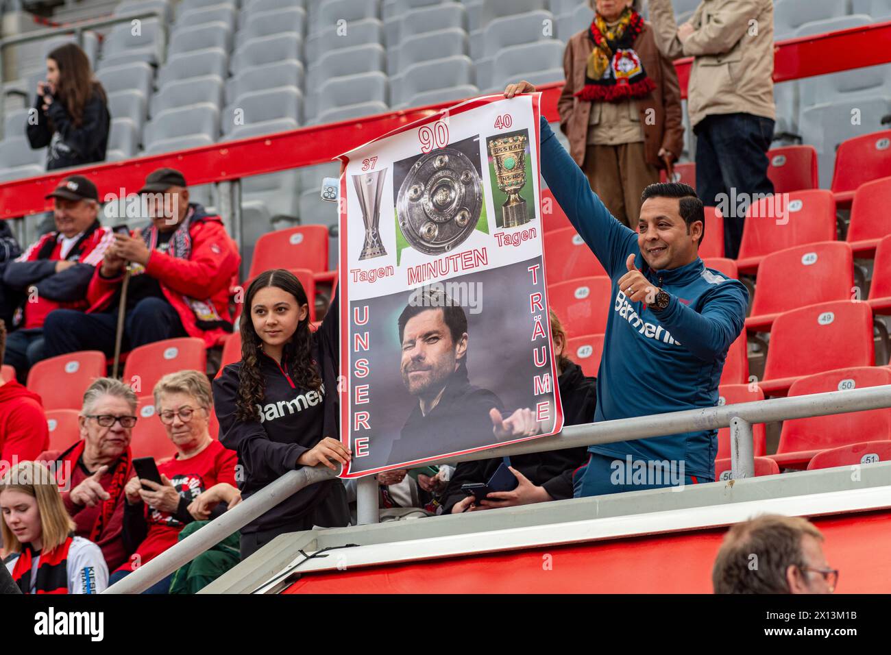 Leverkusen, North Rhine-Westphalia, Germany. 14th Apr, 2024. Bayer Leverkusen fans hold up a sign reading 37 days (until the Europa League Final), 40 days (until the DFB Pokal Final), 90 minutes (before winning the Bundesliga title), with a picture of team head coach XABIER ALONSO with a message that reads ''our dreams'' before the Bundesliga matchday 29 match between Bayer Leverkusen and Werder Bremen in the BayArena in Leverkusen, North Rhine-Westphalia, Germany on April 14, 2024. Credit: ZUMA Press, Inc./Alamy Live News Stock Photo
