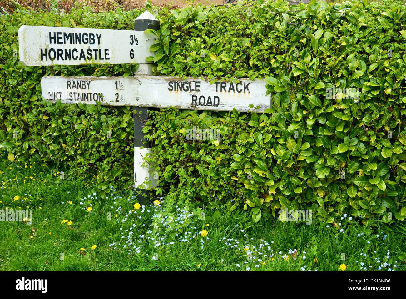 Traditional black and white English roadsigns to local destinations. Stock Photo