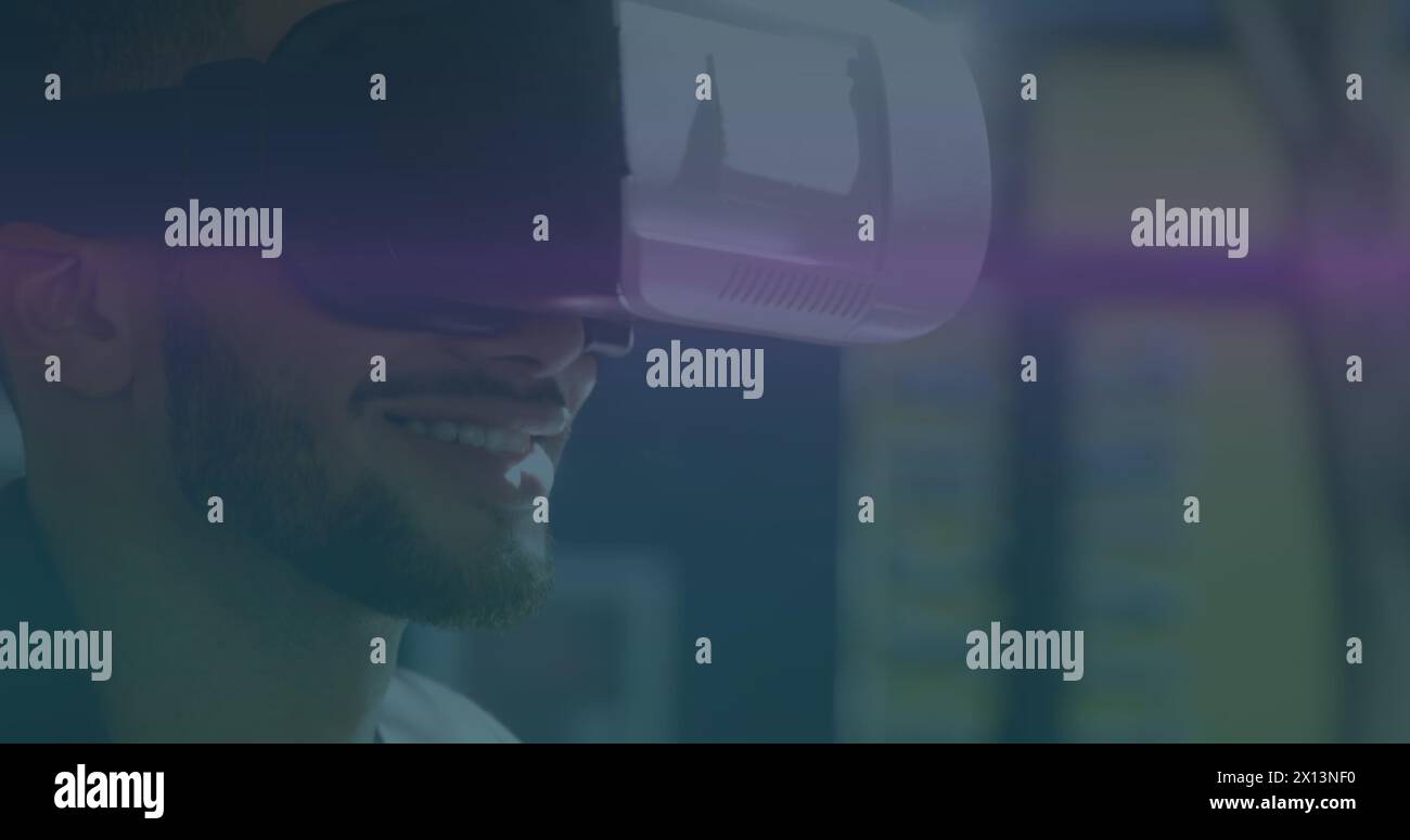 Image of blue and pink light trails moving over biracial man wearing vr ...