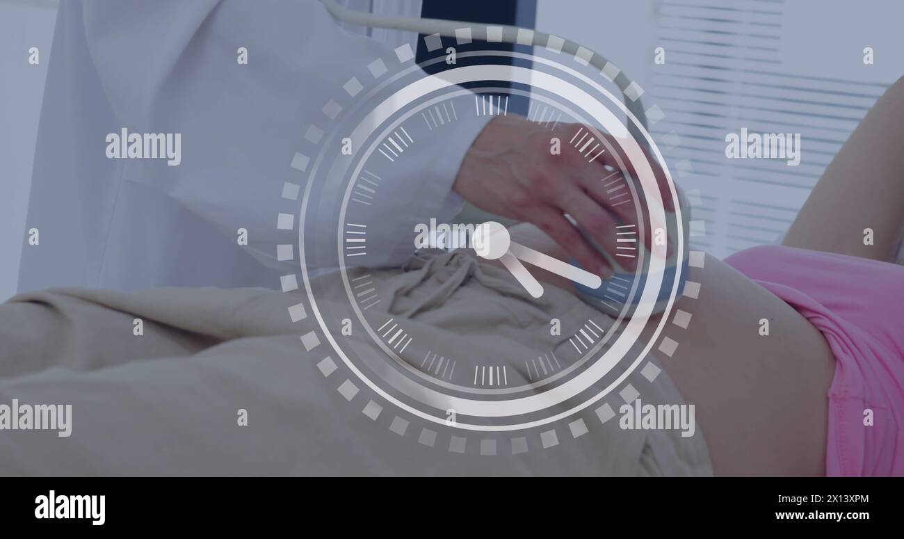 Fast moving hands on clock over caucasian female doctor and pregnant patient having ultrasound scan Stock Photo
