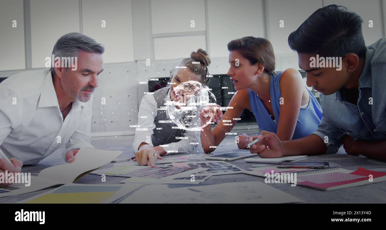 Digital composite of overhead brainstorming in a boardroom between business people with spinning num Stock Photo