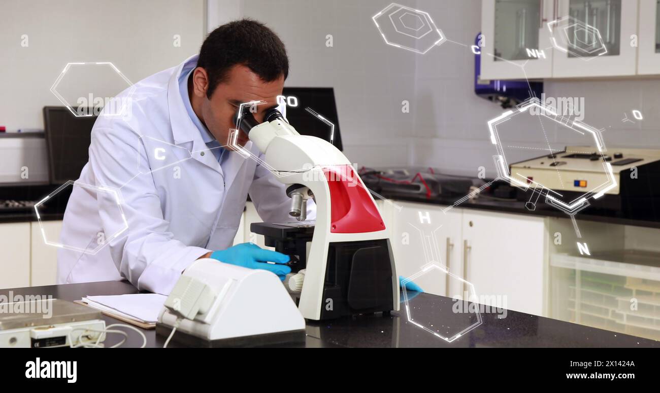 Image of scientific data processing over male scientist using microscope in laboratory Stock Photo