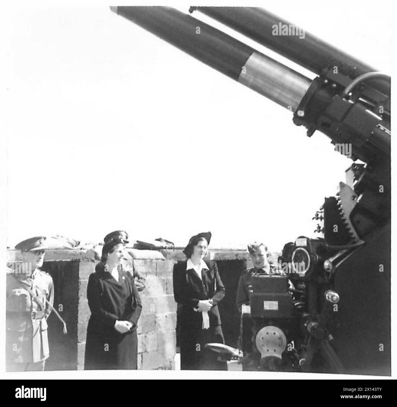 LADY KEMSLEY VISITS AN A.A.GUN SITE - A member of a gun crew explaining