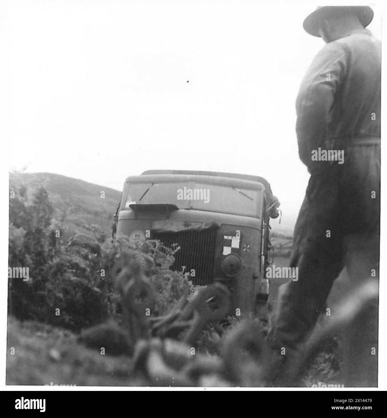 TRAINING ROYAL ARTILLERY DRIVERS - When the gradient becomes too much for the lorry, a wrench is used. An anchor is fitted in the ground, a cable attached and then connected to a winch on the lorry. The winch winds in the cable, and the lorry is hauled up to the top of the hillside British Army Stock Photo