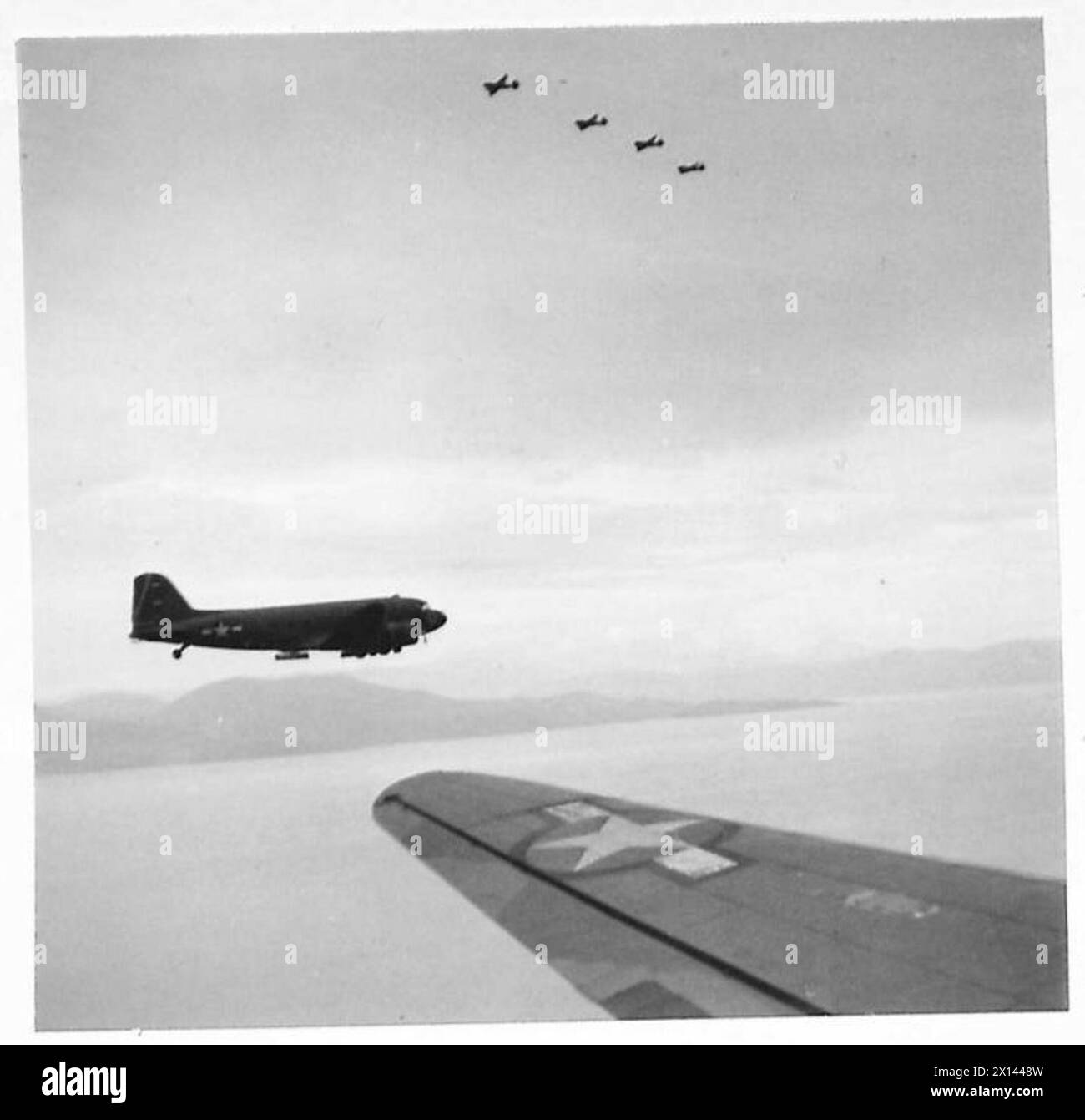 BRITISH PARATROOPS SET OUT ON OPERATION ' MANNA ' - Almost over the Greek coast, and part of the fighter escort can be seen flying over the transport plane British Army Stock Photo