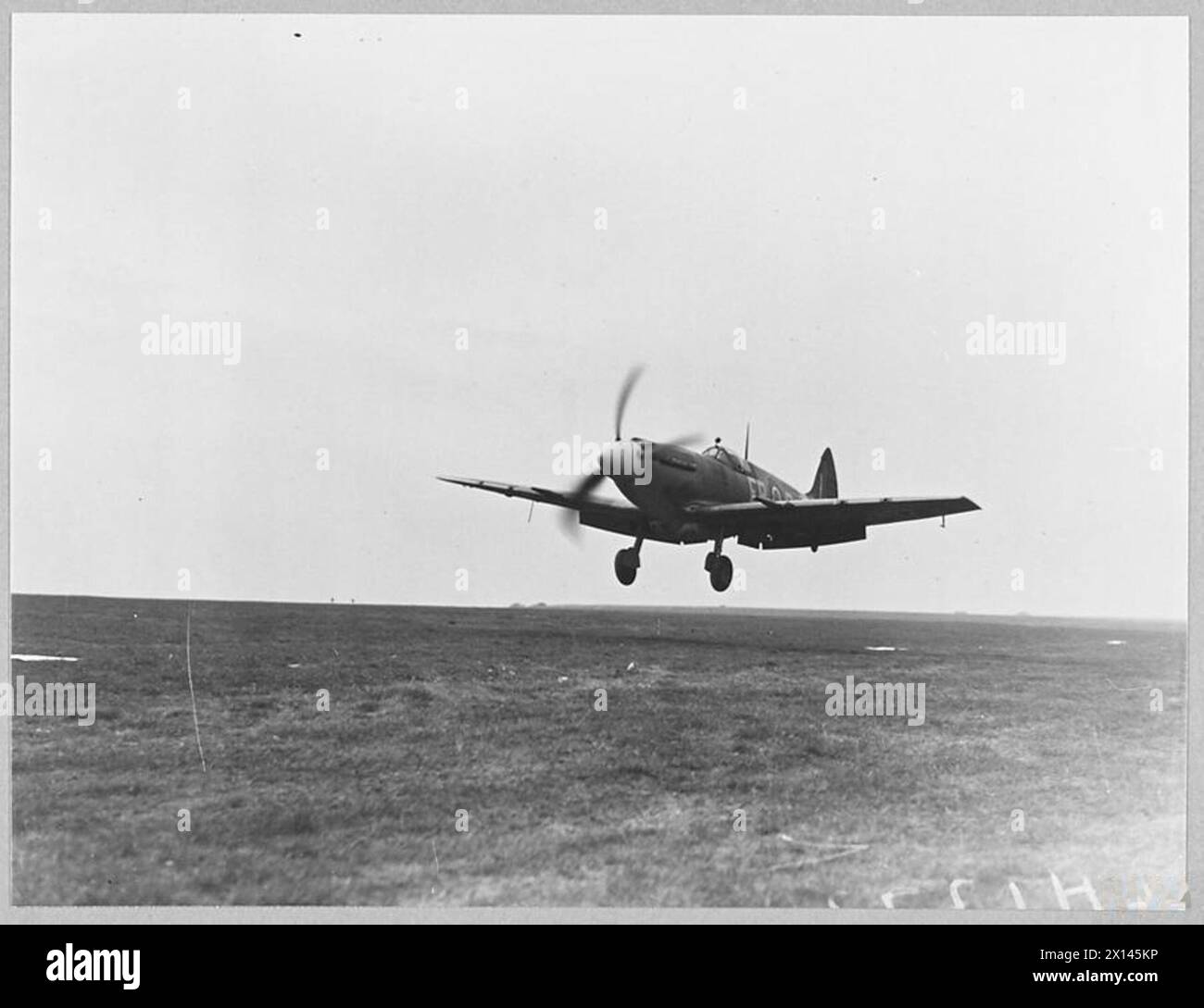THE LATEST SPITFIRE : MARK XII - 12726 Picture (issued 1944) shows - Coming in to land with wheels and flaps down Royal Air Force Stock Photo