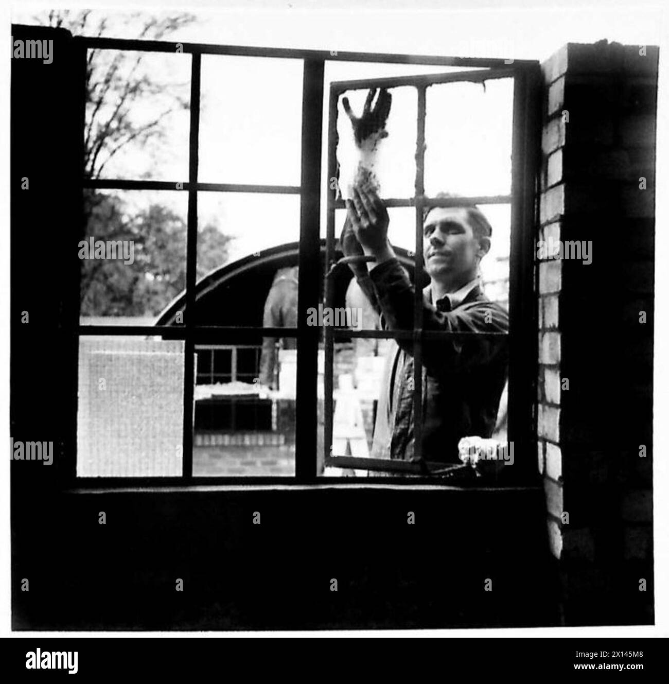 Workers install glass into window frames in Nissen Huts at a newly ...