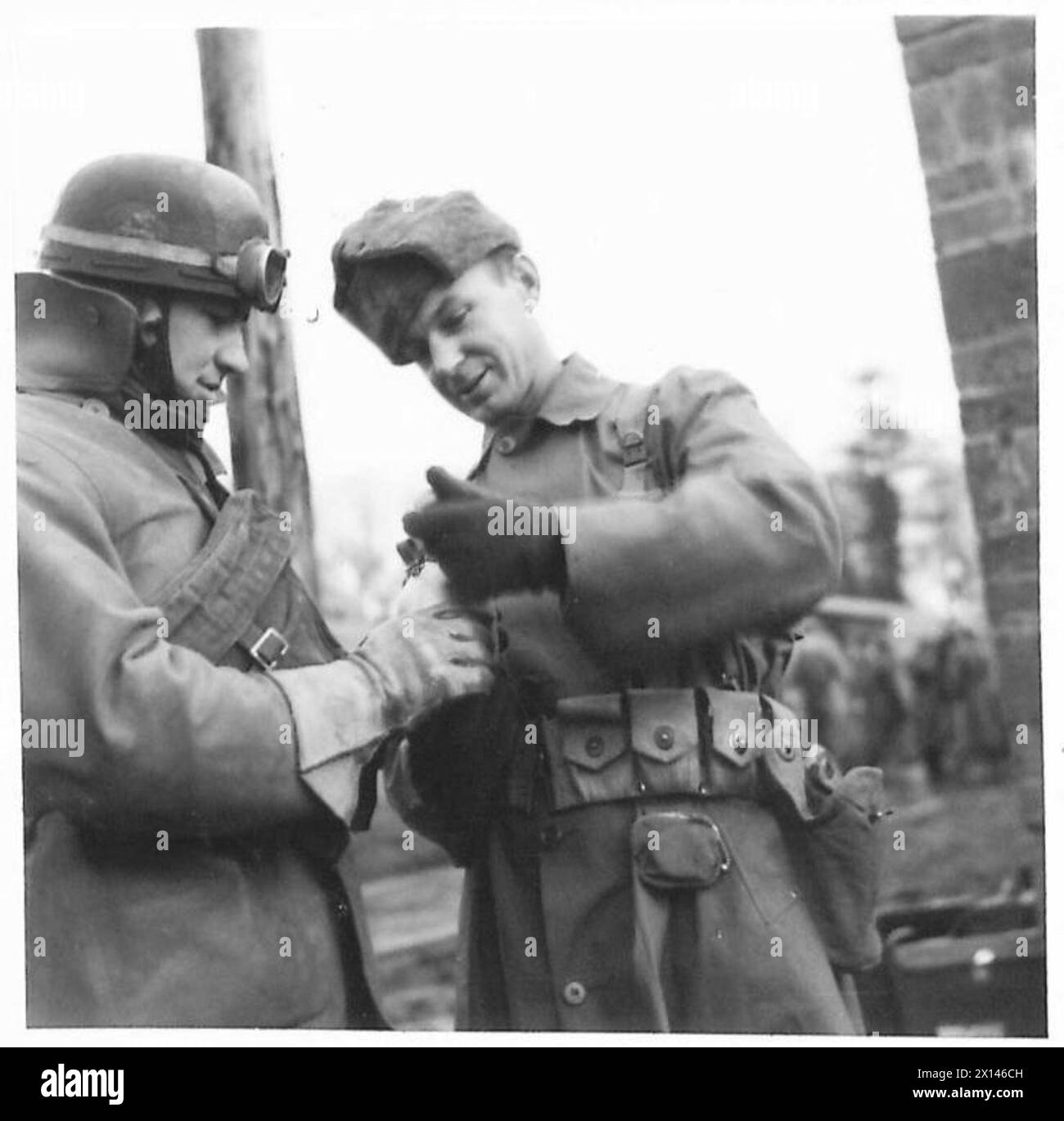 A British despatch rider converses with an American 1st Lieutenant in a ...