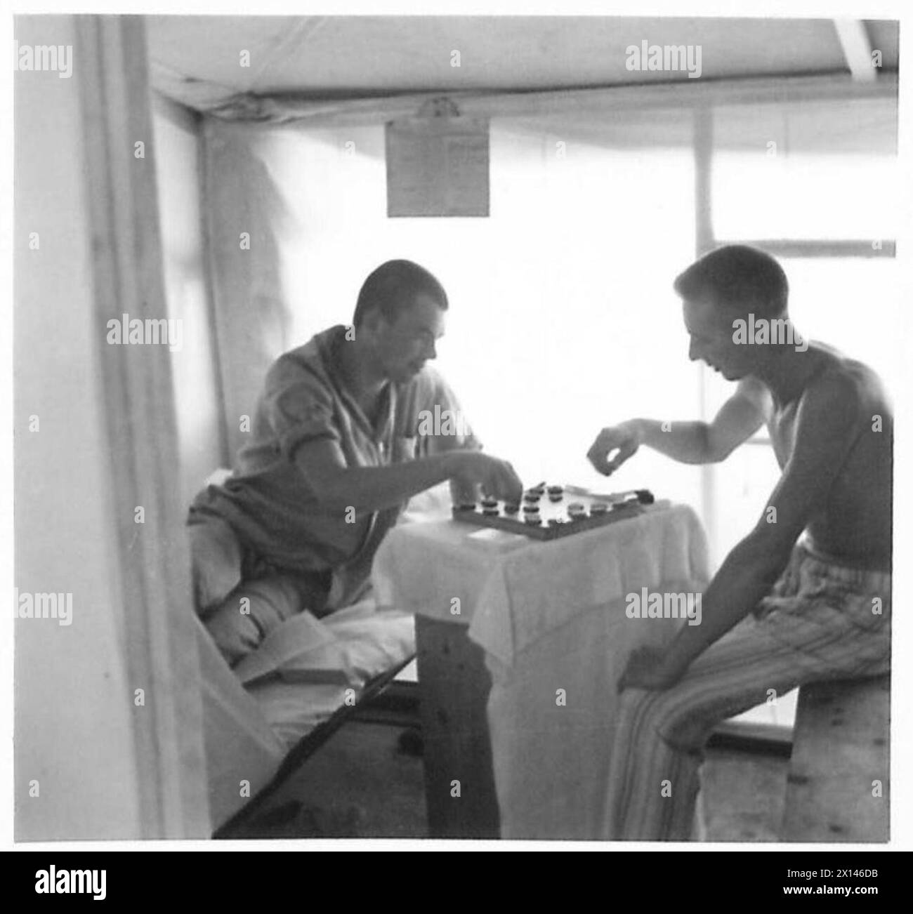 DAILY ROUTINE AT PRISONERS OF WAR CAMP IN WESTERN DESERT - Two German ...