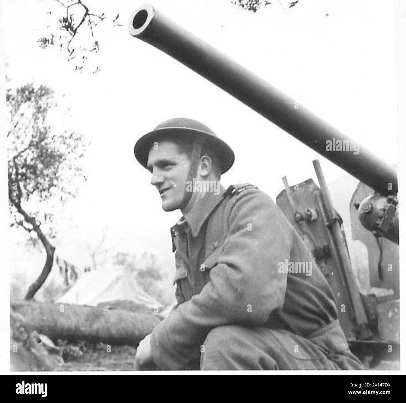 ITALY : FIFTH ARMYSPOT LIGHT ON THE KIWIS - Anti-Tank S/Sgt. W.J. Butler of the 22nd Motorised Battalion, N.Z. Division. 'I think that we will go through them alright. My idea of a good time, is a grand game of rugger, followed by an evening at the Taratshi Hotel with my joker-pals. That's just the 'caper'.' Sgt. Butler is 22 years of age and has been overseas for 3 years. Used to be a fanner, he hails from Solway, Masterton, N.Z British Army Stock Photo