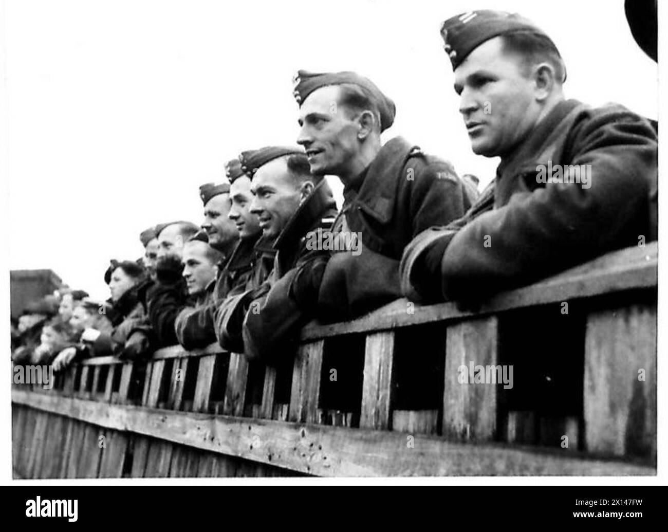 THE POLISH ARMY IN BRITAIN, 1940-1947 - Volunteers from Polish communities in South America, enlisted to the 16th Tank Brigade (1st Polish Corps), watching a football game between Polish and Belgian armies teams. Photograph taken at Forfar. A special series of photographs dealing with the domestic and social life of troops of the 1st Polish Corps in Scotland where the officers and men are firmly established favourites with the local people. Some of the young soldiers were attending universities in Poland when war broke out. On arrival in Britain they joined the Polish Forces and continued thei Stock Photo