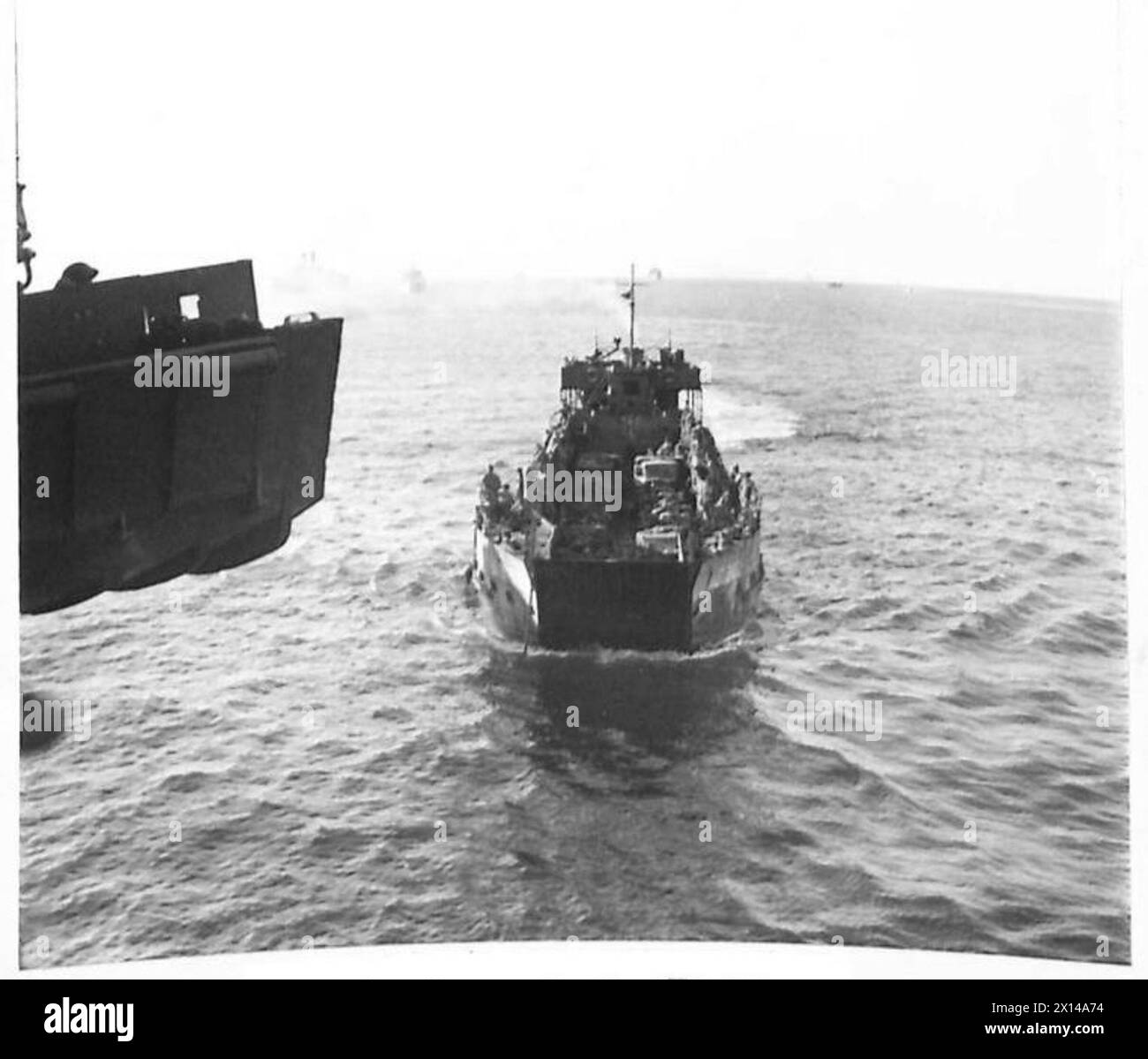 INVASION OF SICILLY - Landing craft carrying troops and equipment ashore British Army Stock Photo